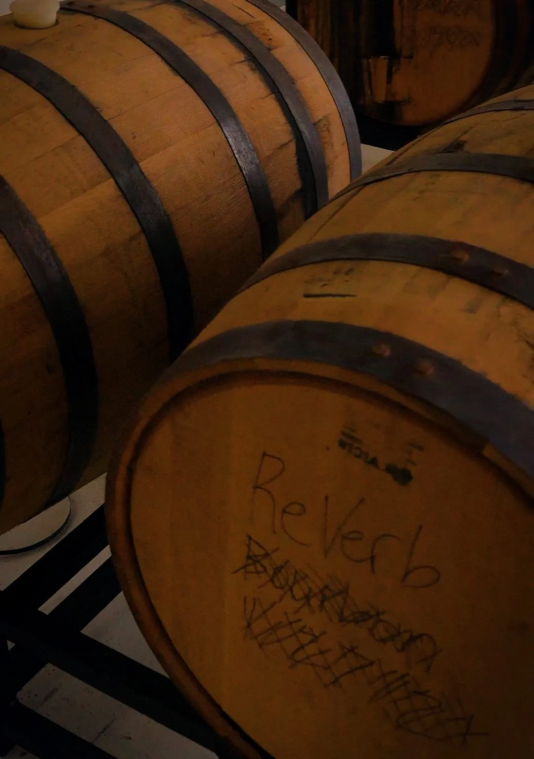A barrel marked ReVerb Bourbon in chalk